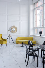 modern fashionable futuristic interior design of a spacious white hall with black and yellow furniture