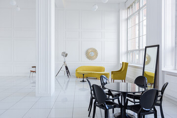 modern fashionable futuristic interior design of a spacious white hall with black and yellow furniture