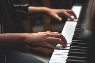 Fototapeta na wymiar young woman performer hands playing piano.