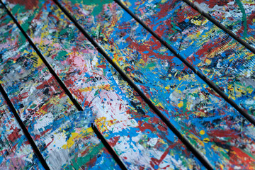 Remains of paint and stains on a wooden base in a studio