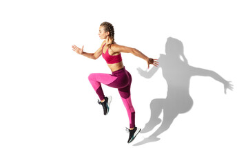 Fototapeta na wymiar Dancing. Beautiful young female athlete practicing on white studio background, portrait with shadows. Sportive fit model in motion and action. Body building, healthy lifestyle, style concept.