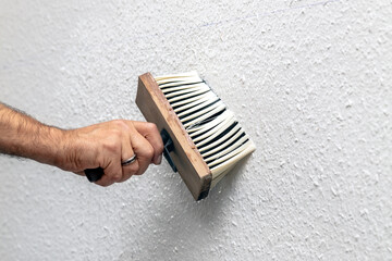 wallpaper is soaked with a brush and water