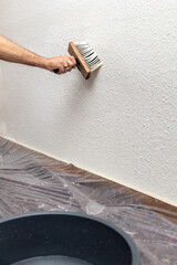 wallpaper is soaked with a brush and water