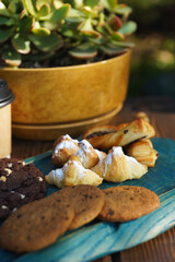 Various types of pastries and cookies on a wooden board