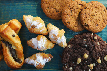 Various types of pastries and cookies on a wooden board