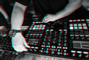 hands of a male DJ on the background of music professional equipment