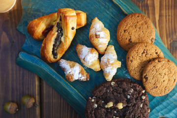 Various types of pastries and cookies on a wooden board