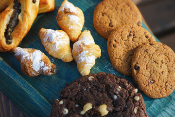 Various types of pastries and cookies on a wooden board
