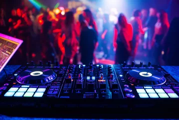 Fotobehang music controller DJ mixer in a nightclub at a party © alexkoral