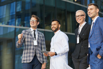 Successful business people looking away and smiling while standing in the city