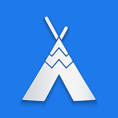 Paper cut Traditional indian teepee or wigwam icon isolated on blue background. Indian tent. Paper art style. Vector. © Vadim