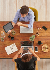 Man is giving some information about the job to the women, wooden working table style up concept.