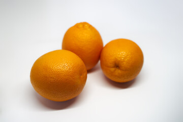 Photo of three oranges on a white background