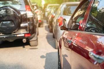 Long line of cars on urban street with rear view