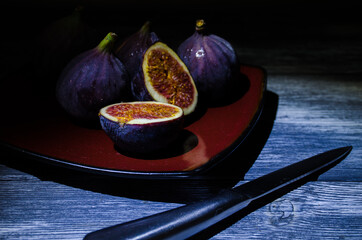 Still life with figs on the wooden background