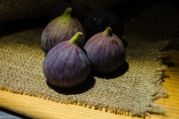 Still life with figs on the wooden background