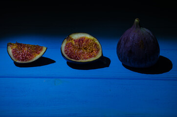 Still life with figs on the wooden background