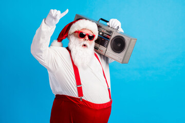 Fototapeta na wymiar Photo of cool hispter santa claus with beard stomach listen x-mas christmas boom box wear red style stylish trendy suspenders overalls cap isolated over blue color background