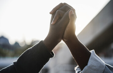 Black people holding hands during protest for no racism - Empowerment, unity power and equal rights...