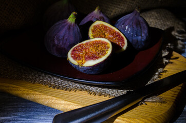 Still life with figs on the wooden background