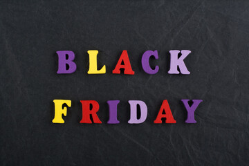 BLACK FRIDAY word on black board background composed from colorful abc alphabet block wooden letters, copy space for ad text. Learning english concept.