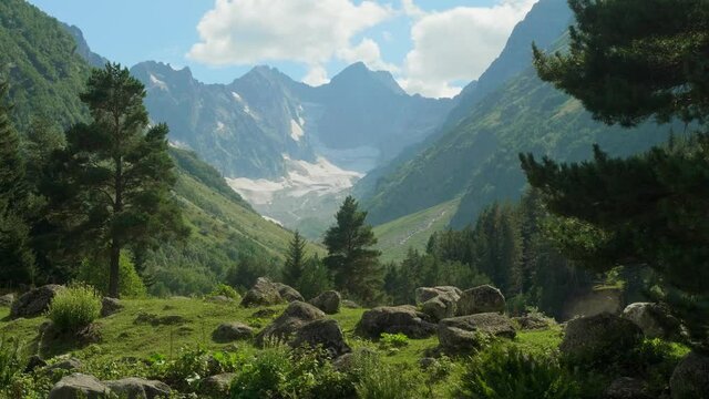 View of green sole of ravine Makhar in Russia with blue sky and white coulds above.