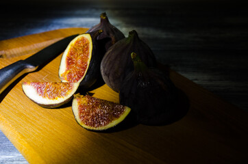 Still life with figs on the wooden background