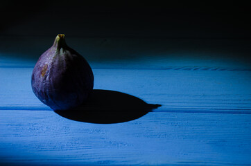 Still life with figs on the wooden background