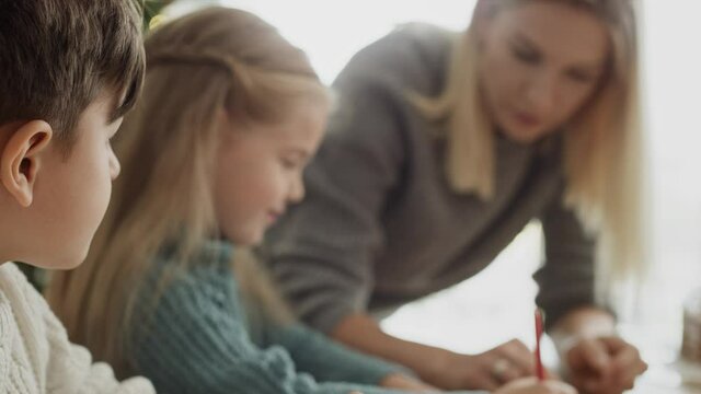 Video of children writing a letter to Santa Claus. Shot with RED helium camera in 8K.
