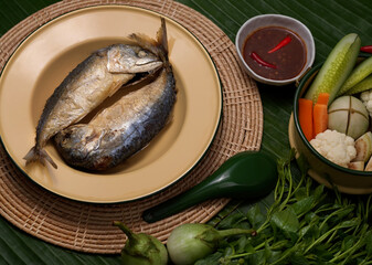 Top view of fried mackerels with shrimp paste sauce and vegetable set served on Thai traditional plate