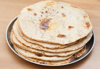 Stack of fresh wholewheat flatbread with butter