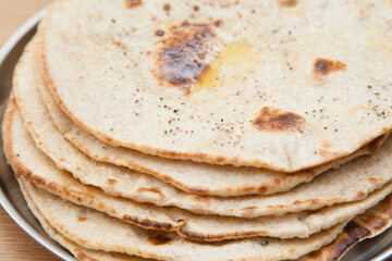 Closeup of fresh wholewheat flatbread with butter