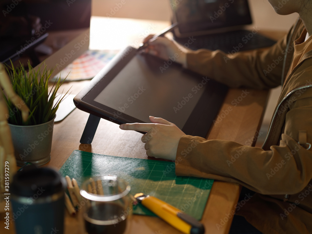 Poster female hands working with drawing tablet and computer on worktable