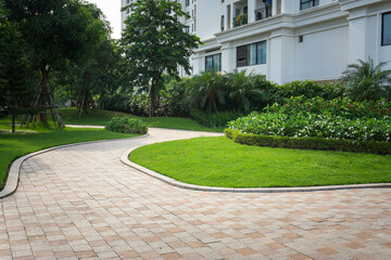 Urban walking road among green tree in modern apartment buildings in big city.