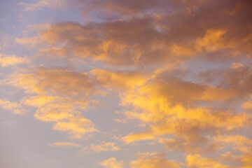 Naklejka na ściany i meble Golden clouds at sunset