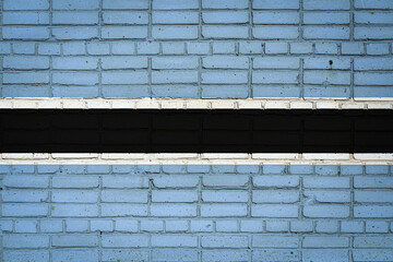 National flag of Botswana depicting in paint colors on an old brick wall. Flag  banner on brick wall background.