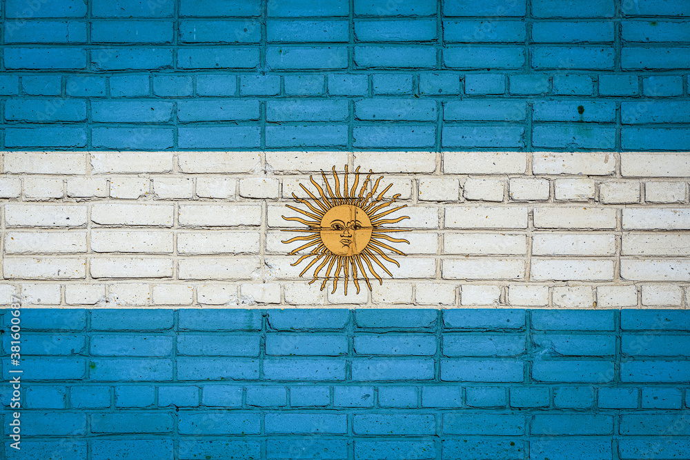 Wall mural national flag of argentina depicting in paint colors on an old brick wall. flag banner on brick wall