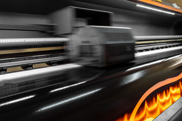 Obraz premium Drying the prints by heating. Printing machine that dries the print with its heated fans. Large format digital printing machine and moving print head.