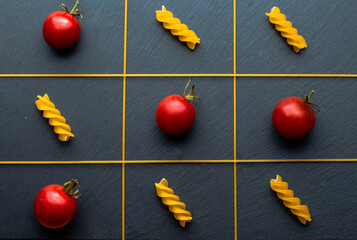 Tic-tac-toe from pasta and tomatoes.