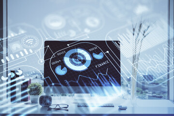 Fototapeta premium Computer on desktop in office with technology theme hologram. Double exposure. Tech concept.