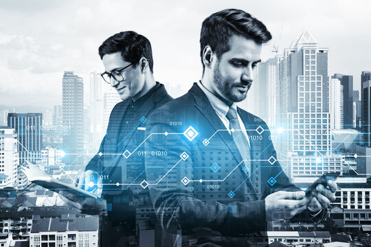 Two handsome businessman working on technology at business process to achieve tremendous growth in commerce. Worldwide process to conduct transactions. Tech hologram icons over Kuala Lumpur background