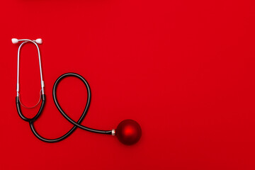 Medical Christmas banner with stethoscope on red background. 