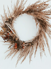 Fall wreath made of dried herbs, flowers, berries, wildflowers