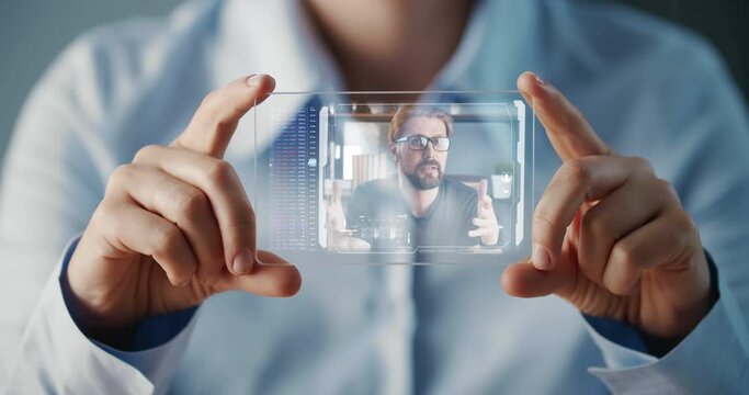 Woman using futuristic hologram pad for video call, future communication concept