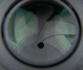 photograph of the 50mm lens of a camera showing the curtains of the same with a very closed diaphragm