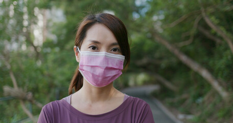 Women wear a face mask and look at the camera