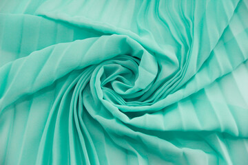 green synthetic fabric with a pleats