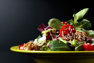 Green salad with cherry tomatoes,  sesame, walnuts and vegetable oil.