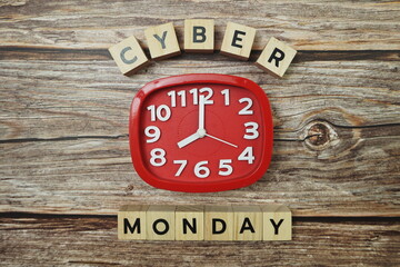 Cyber Monday with clock on wooden background