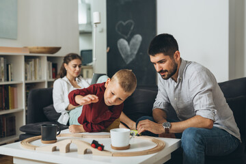 young happy family sharing family time playing with toys at home.